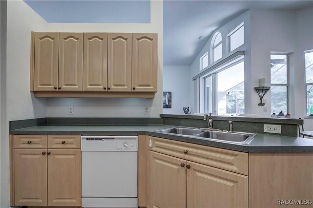 8583 N Tibet Ter, Dunnellon, FL 34433 - kitchen with white dishwasher, light brown cabinets, dark countertops, a peninsula, and lofted ceiling