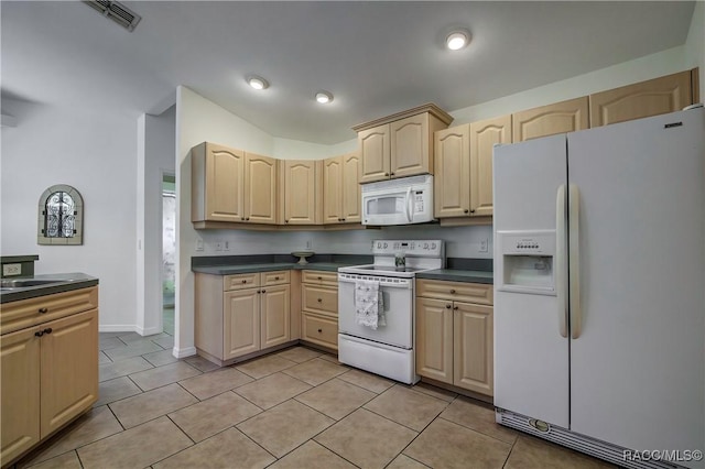 8583 N Tibet Ter, Dunnellon, FL 34433 - kitchen featuring white appliances, light brown cabinets, dark countertops, light tile patterned flooring, and vaulted ceiling