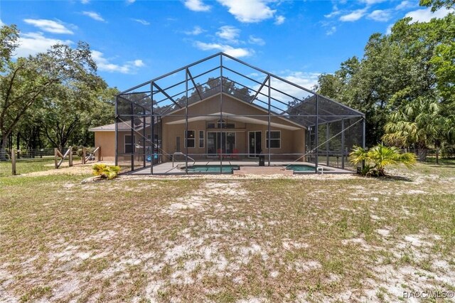 8583 N Tibet Ter, Dunnellon, FL 34433 - back of house with an outdoor pool, a patio, ceiling fan, and a lanai