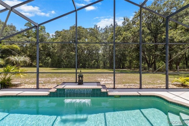 8583 N Tibet Ter, Dunnellon, FL 34433 - swimming pool with glass enclosure and a lawn
