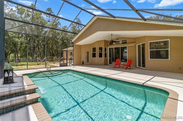8583 N Tibet Ter, Dunnellon, FL 34433 - swimming pool featuring a patio, a ceiling fan, and a lanai