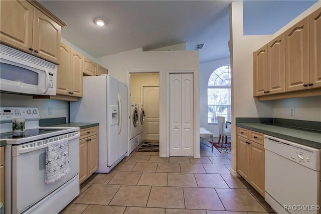 8583 N Tibet Ter, Dunnellon, FL 34433 - kitchen with white appliances, separate washer and dryer, dark countertops, light brown cabinets, and vaulted ceiling