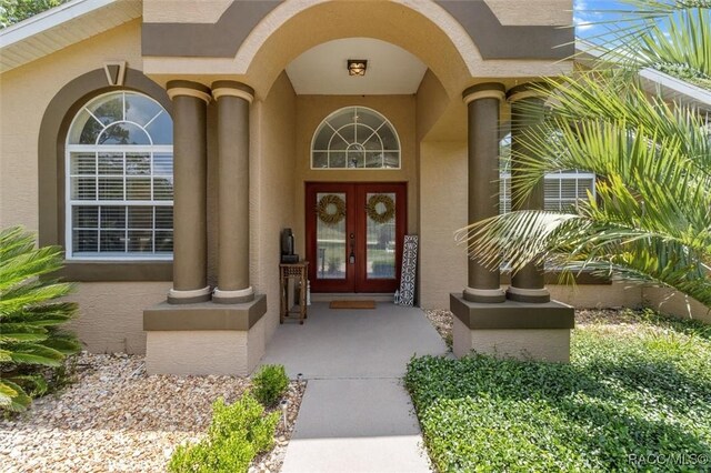 8583 N Tibet Ter, Dunnellon, FL 34433 - doorway to property with french doors and stucco siding