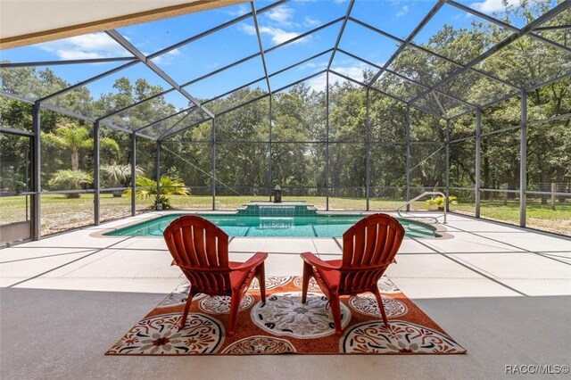8583 N Tibet Ter, Dunnellon, FL 34433 - swimming pool featuring a patio area, view of wooded area, and glass enclosure