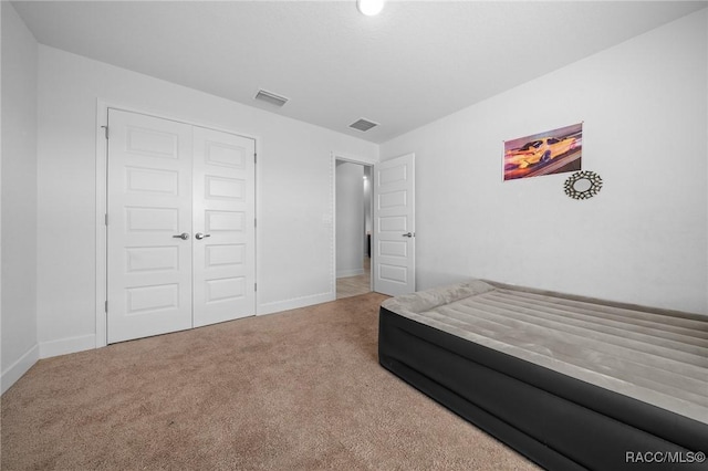 carpeted bedroom with a closet