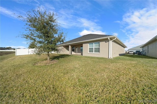 rear view of property with a lawn