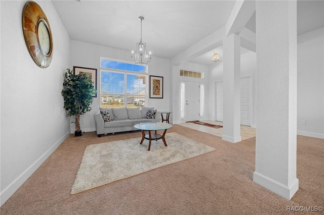 living room featuring light carpet and an inviting chandelier