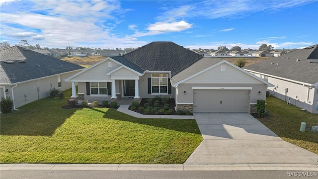 view of front of home featuring a garage, a front lawn, and a porch