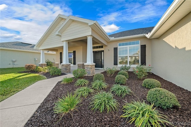 5826 SW 83rd Ln, Ocala, FL 34476 - doorway to property with stucco siding, a lawn, a porch, and stone siding