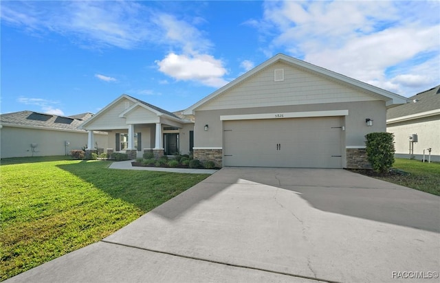 view of front of home with a front lawn, covered porch, and a garage