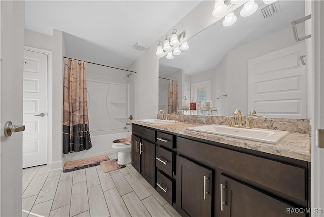 full bathroom featuring toilet, vanity, and shower / bath combo with shower curtain