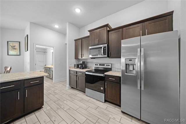 kitchen featuring appliances with stainless steel finishes and dark brown cabinets