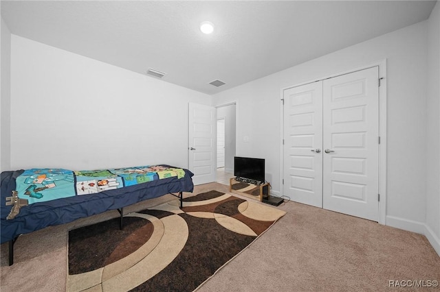 carpeted bedroom with a closet