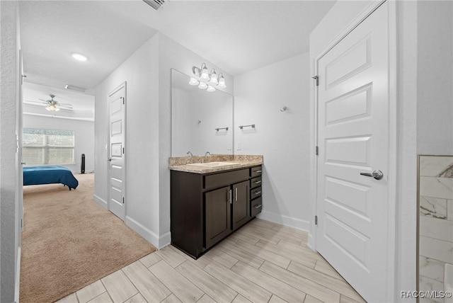 bathroom with ceiling fan and vanity