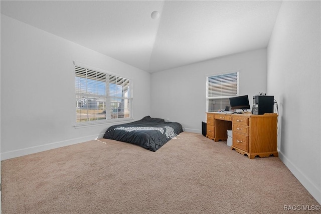 carpeted bedroom featuring lofted ceiling