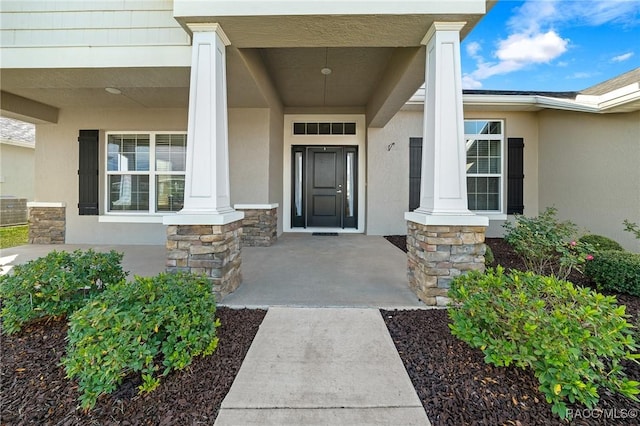 entrance to property with a porch and central air condition unit