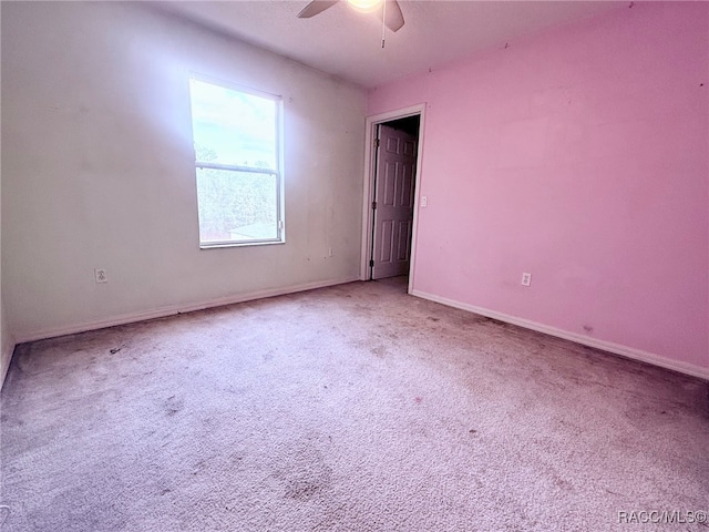 spare room featuring carpet flooring and ceiling fan