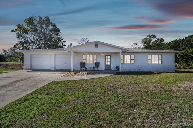 single story home with a lawn and a garage