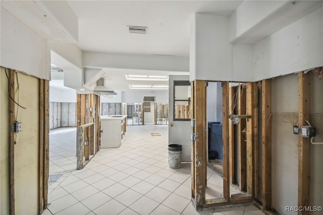 hall with light tile patterned floors