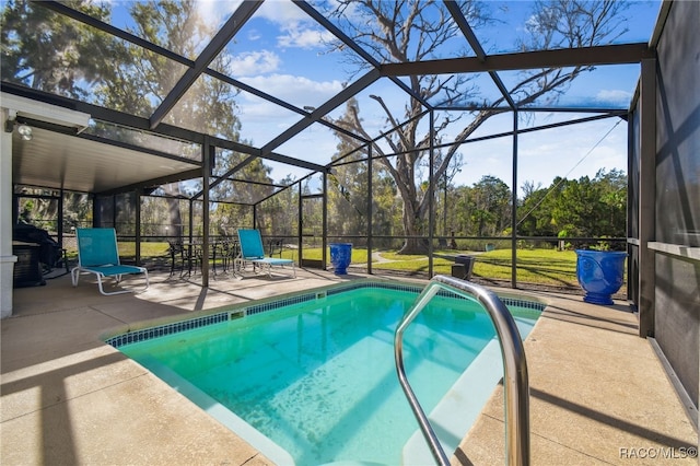 view of swimming pool with glass enclosure and a patio