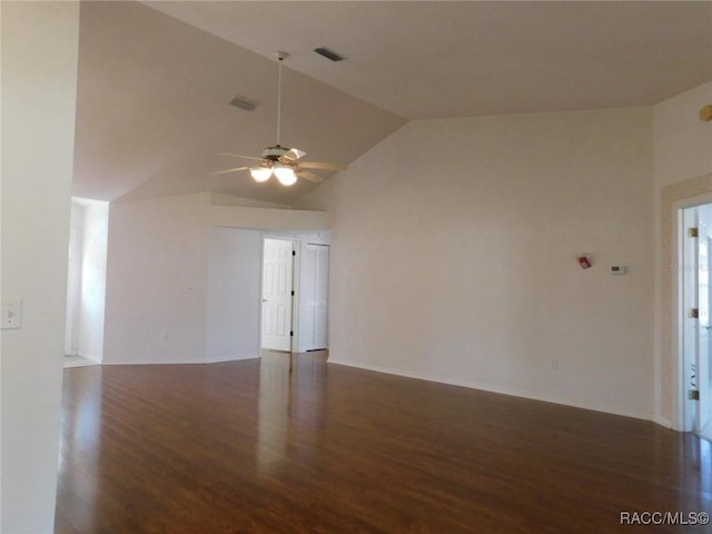 empty room featuring dark wood-type flooring, ceiling fan, and vaulted ceiling