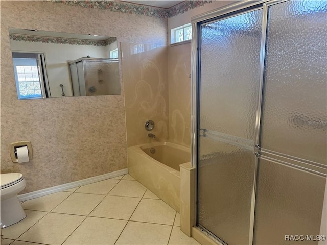 bathroom featuring toilet, tile patterned floors, plenty of natural light, and plus walk in shower