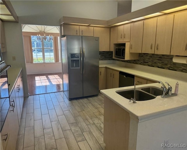 kitchen with sink, a chandelier, decorative backsplash, stainless steel appliances, and light brown cabinets