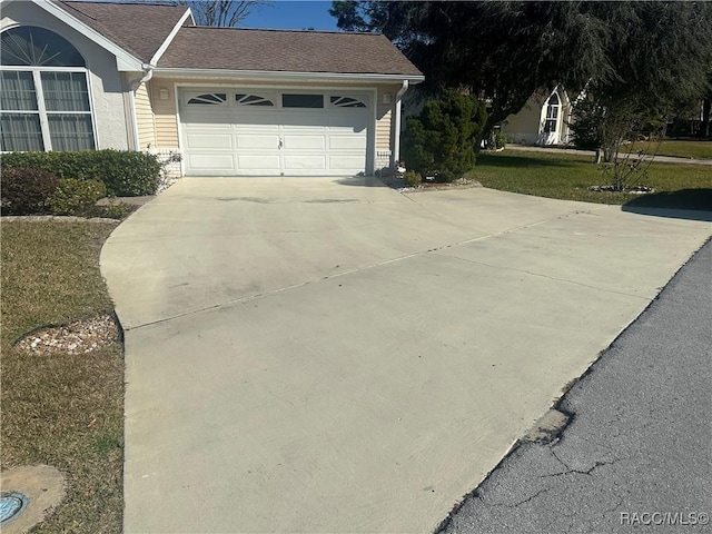 view of property exterior featuring a lawn and a garage