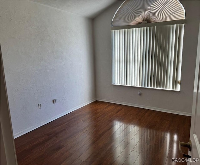 unfurnished room with dark hardwood / wood-style flooring