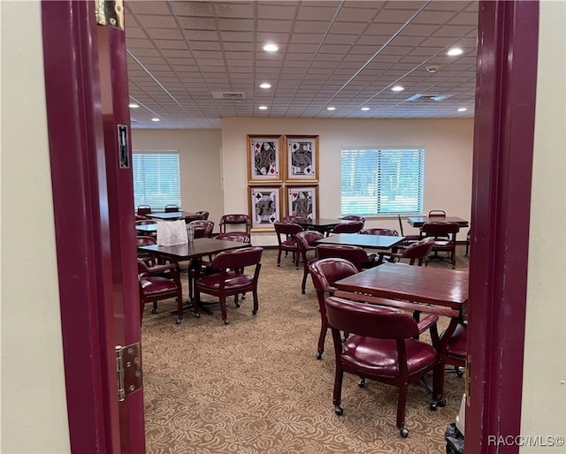 dining room featuring a drop ceiling