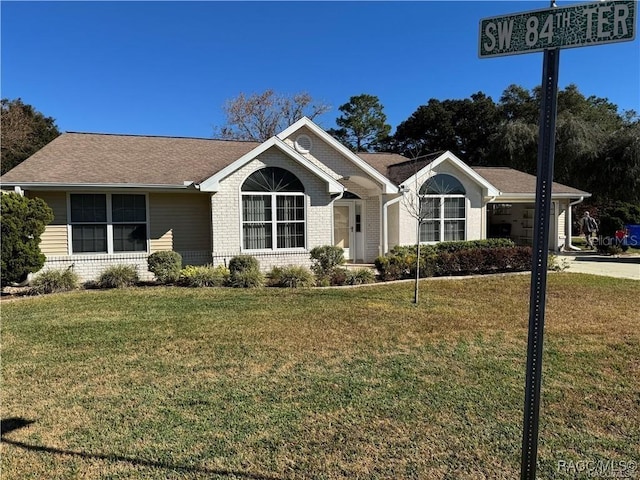 ranch-style home with a garage and a front yard