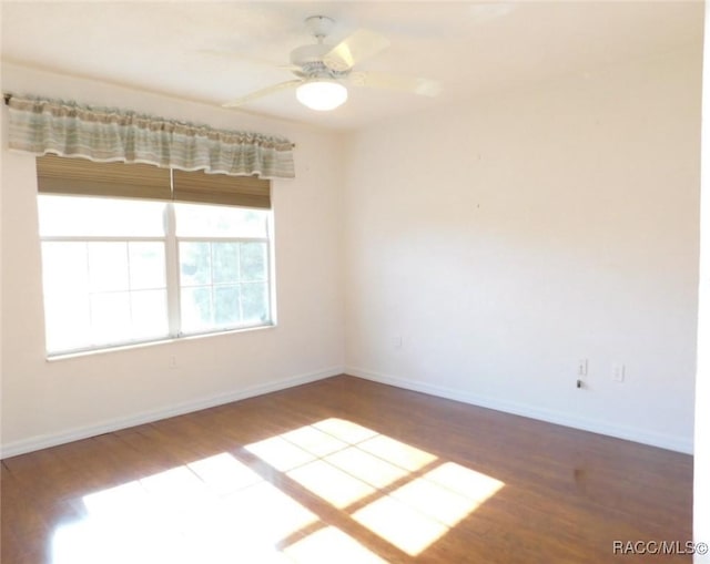 empty room featuring wood-type flooring and ceiling fan