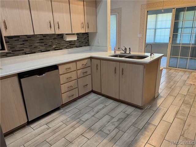 kitchen with kitchen peninsula, light brown cabinetry, backsplash, sink, and dishwasher