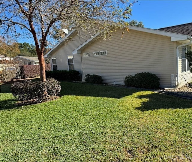 view of side of property with a lawn