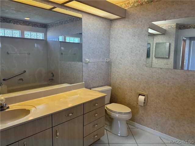 bathroom featuring tile patterned floors, toilet, and vanity