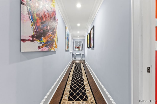 hallway with hardwood / wood-style floors and crown molding