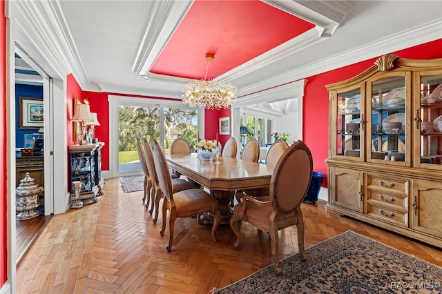 dining space with an inviting chandelier, parquet floors, and crown molding