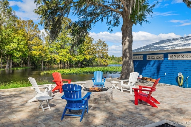 view of patio featuring a fire pit and a water view