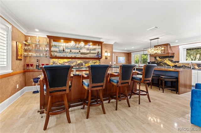 bar with custom range hood, decorative light fixtures, crown molding, and sink