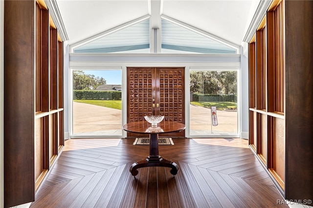 sunroom / solarium featuring vaulted ceiling with beams and plenty of natural light