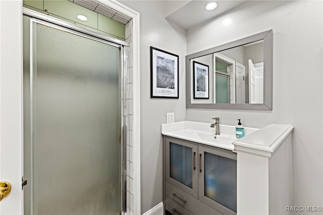 bathroom featuring vanity and a shower with shower door