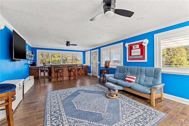 living room featuring a textured ceiling, plenty of natural light, dark hardwood / wood-style floors, and ornamental molding