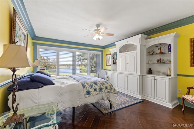 bedroom featuring ceiling fan, ornamental molding, and dark parquet floors