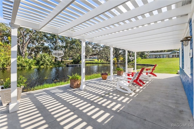 view of patio / terrace with a pergola and a water view