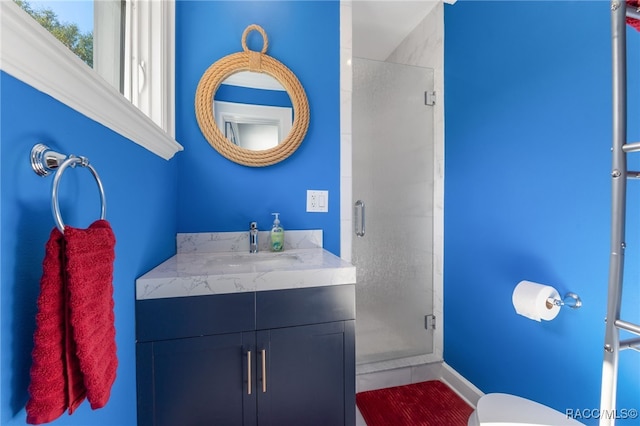 bathroom featuring vanity, toilet, and walk in shower