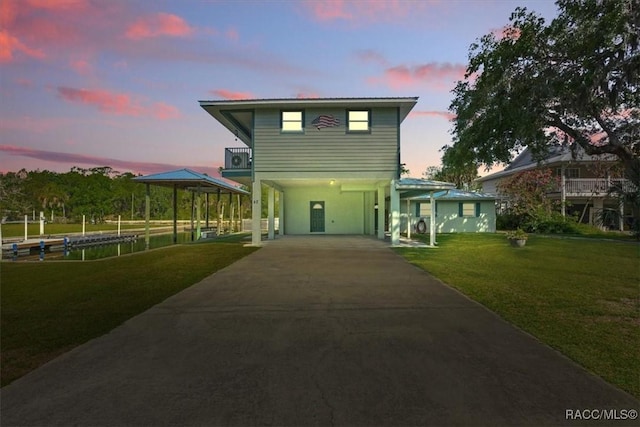 42 Magnolia Ave, Yankeetown, FL 34498 - view of front of home with a carport, a front lawn, concrete driveway, and a gazebo