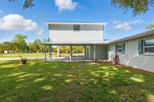 42 Magnolia Ave, Yankeetown, FL 34498 - back of property featuring a patio and a yard