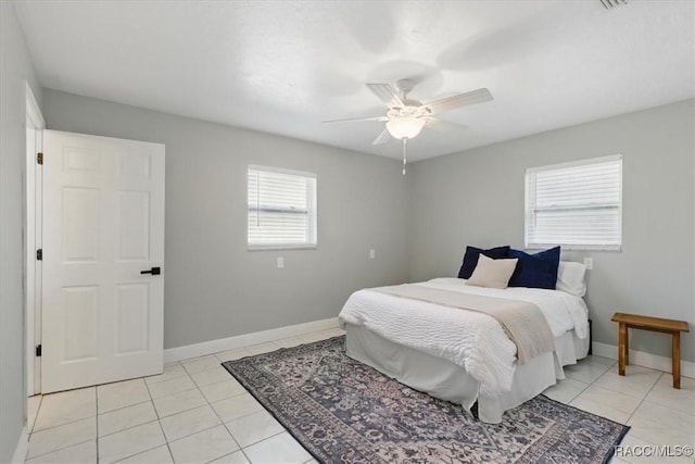 42 Magnolia Ave, Yankeetown, FL 34498 - bedroom with light tile patterned floors, baseboards, and a ceiling fan