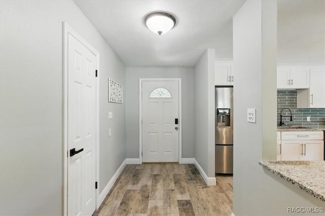 42 Magnolia Ave, Yankeetown, FL 34498 - foyer entrance featuring light wood-style floors and baseboards