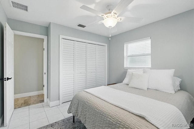 42 Magnolia Ave, Yankeetown, FL 34498 - bedroom with a closet, light tile patterned floors, a ceiling fan, and baseboards